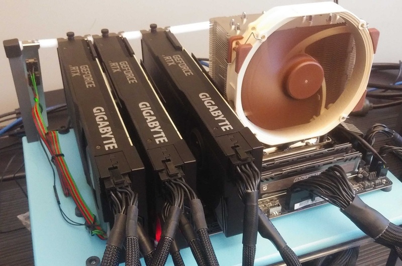 Three Gigabyte NVIDIA GeForce RTX 3090 Turbo video cards on an open test bed in Puget Labs
