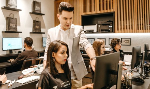 Instructor Teaching Students on Computers