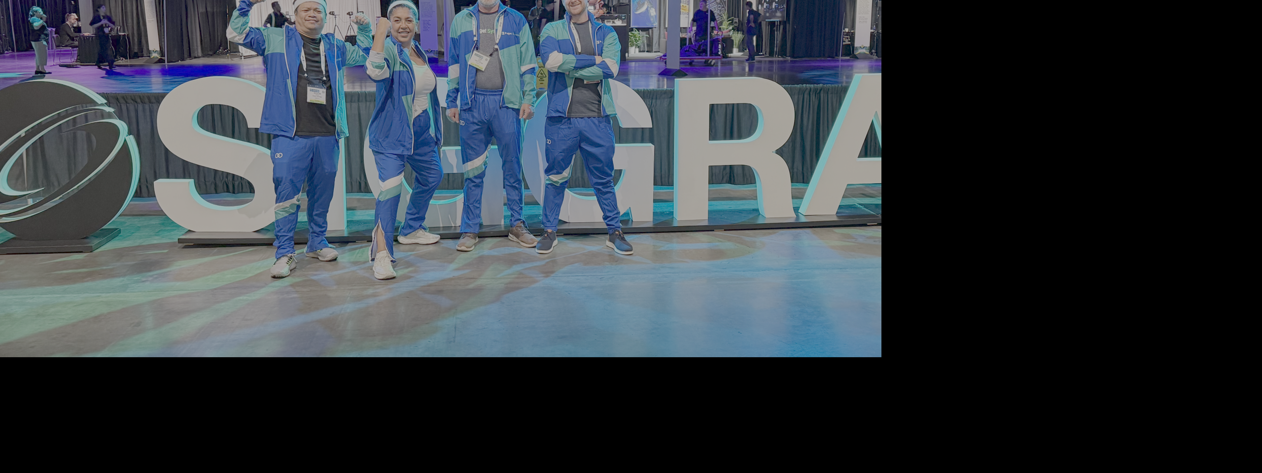 Puget Systems staff posing in front of "SIGGRAPH" sign at event entrance